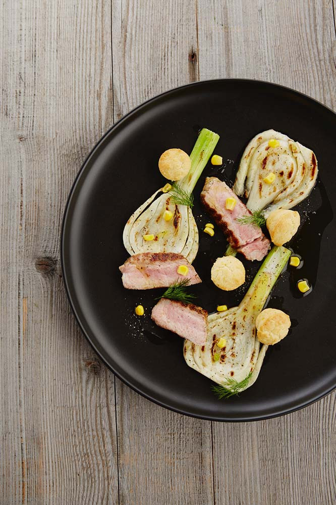 Baked veal oyster on grilled fennel with corn cake and drops