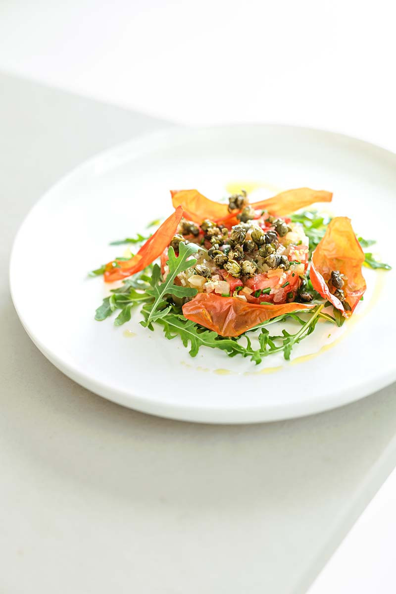 Yacon tartare with tomato, shallot & lime, served with capers, chives & rocket