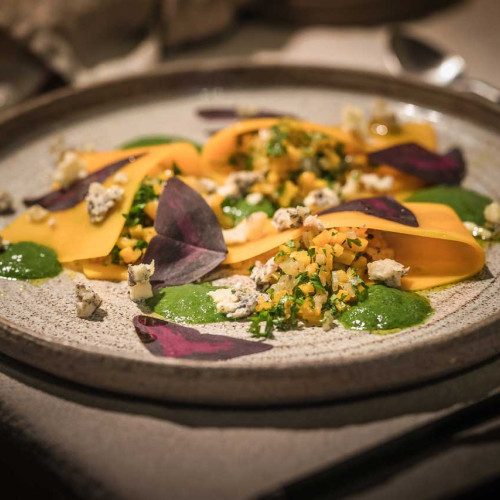 Open pumpkin ravioli with Achelse blue crumble, parsley sauce and Yka leaves.