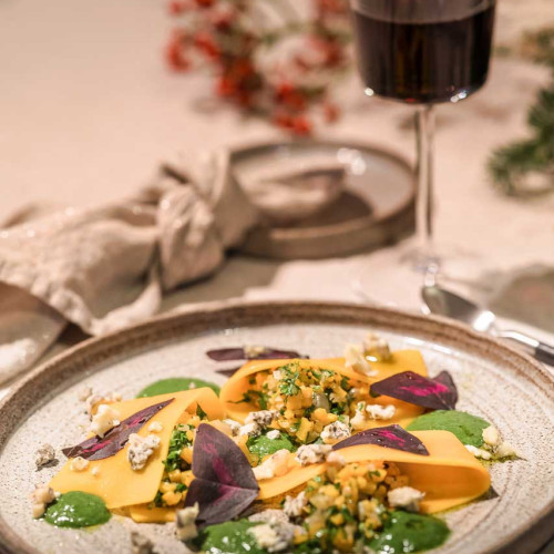 Open pumpkin ravioli with Achelse blue crumble, parsley sauce and Yka leaves.